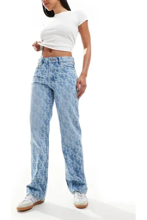 Calvin Klein Signature 90s all over print jeans in mid