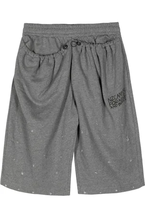 Natasha Zinko Slogan-print distressed cotton track shorts