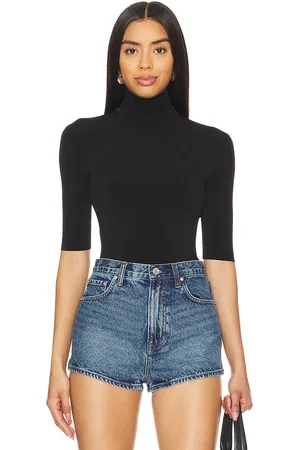 Norma Kamali Slim Fit Short Sleeve Turtleneck Top in - . Size L (also in M, S, XL, XS).