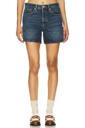 RE/DONE Mid Rise Boy Short in - Denim-Dark. Size 25 (also in 30).