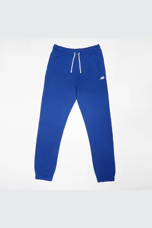New Balance French Terry Small Logo Jogger unissexo Calças de treino azul tamanho 170 Vestuário